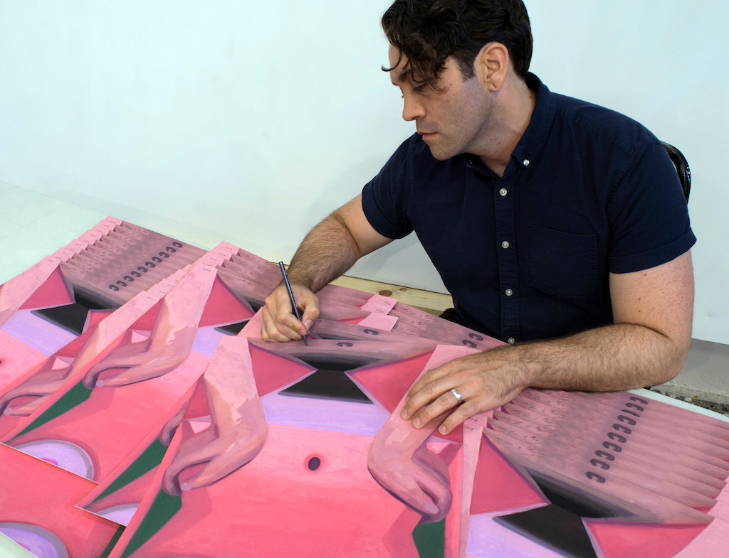 Photo of artist Corey Lamb signing prints of his work "Days" 