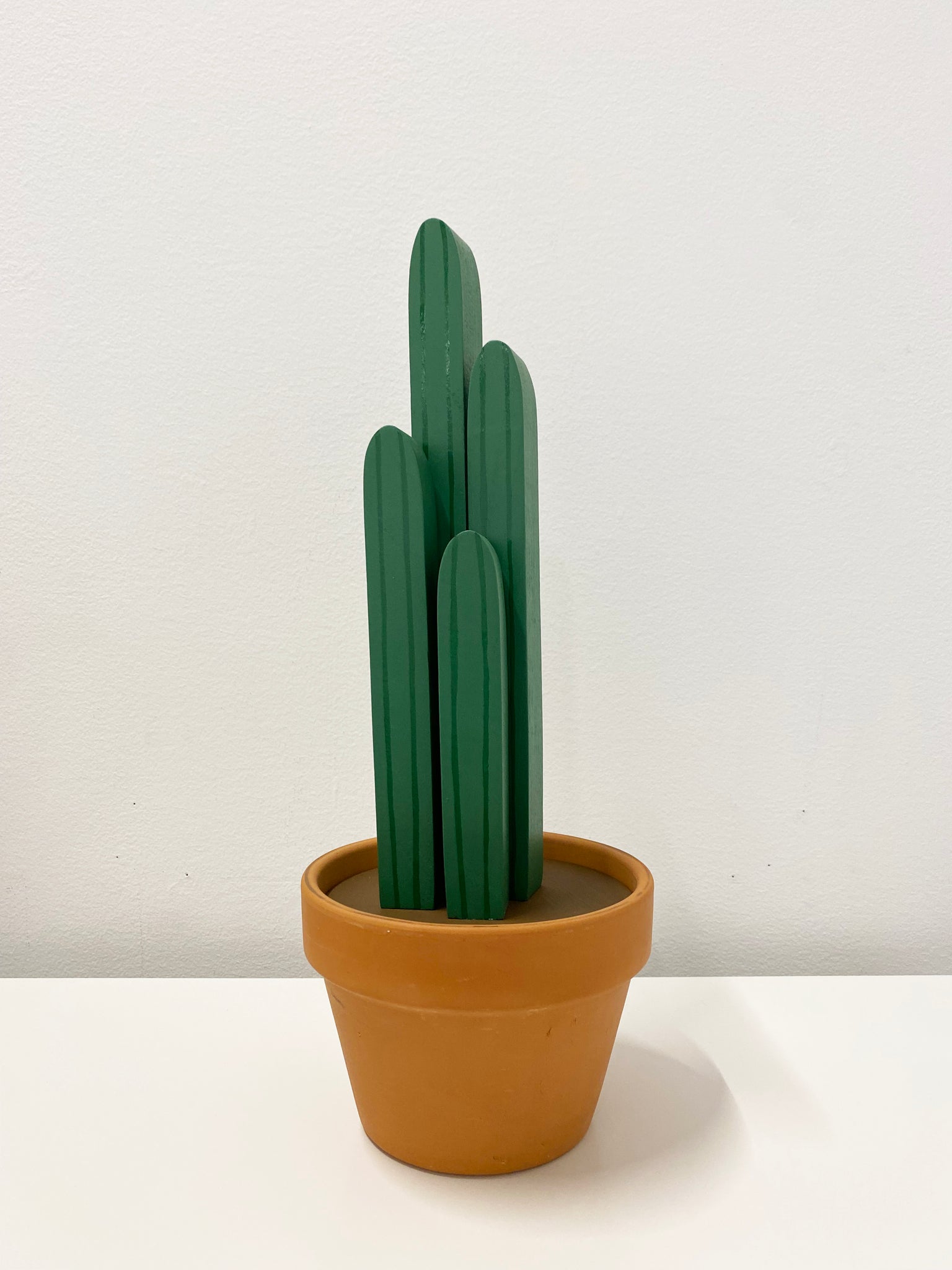Wooden sculpture of a cactus in a terracotta pot