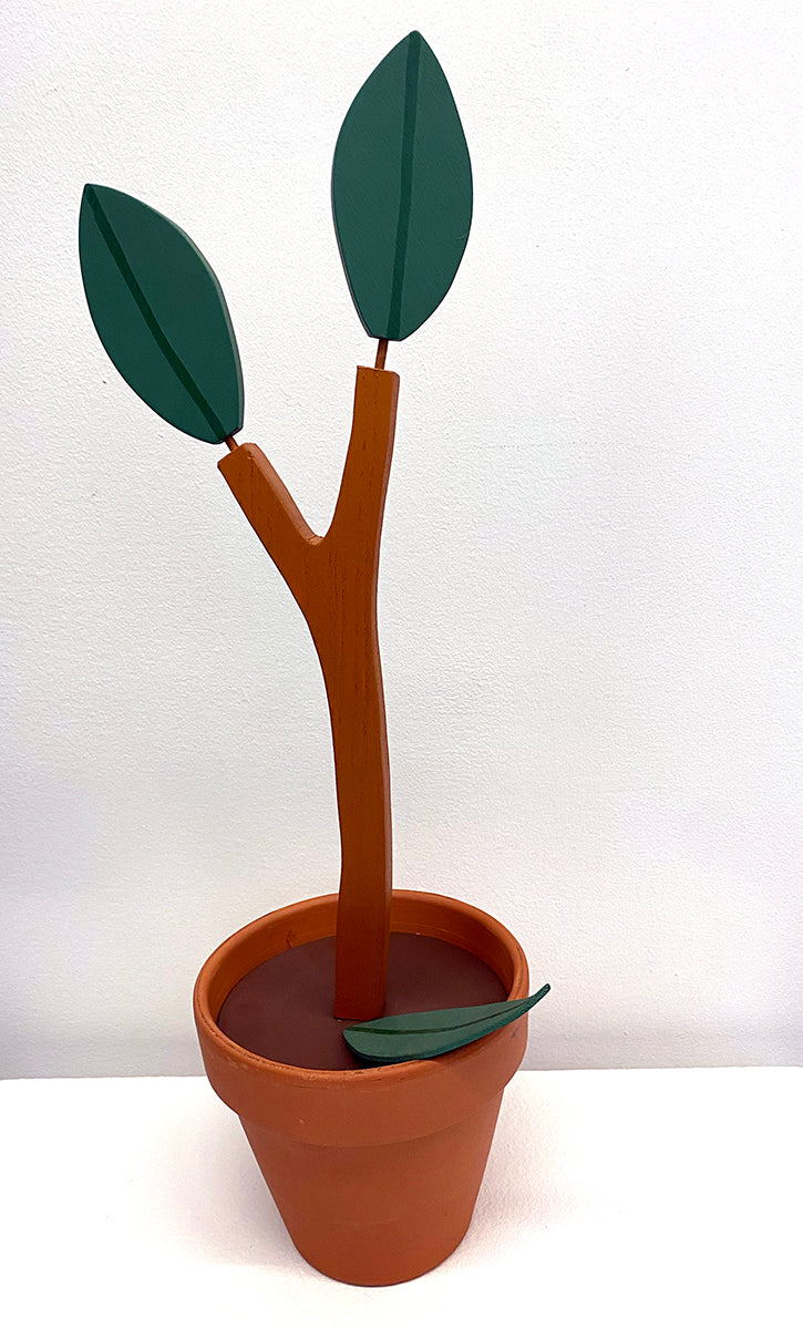 Wooden sculpture of a plant with two leaves in a terracotta pot