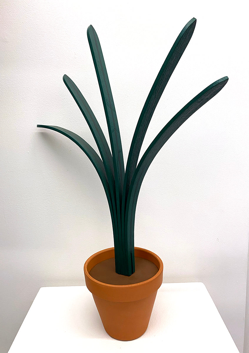 wooden sculpture of plant in terracotta pot