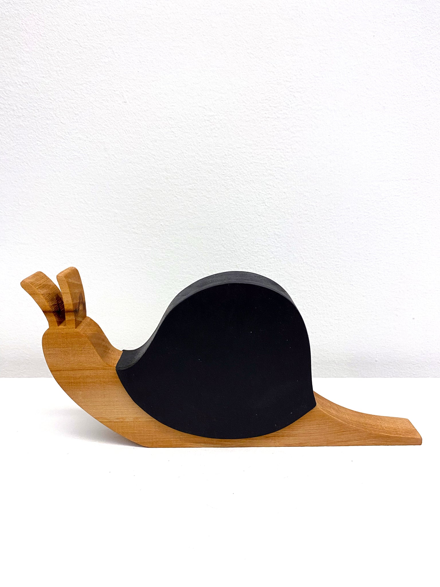 wooden sculpture of a snail