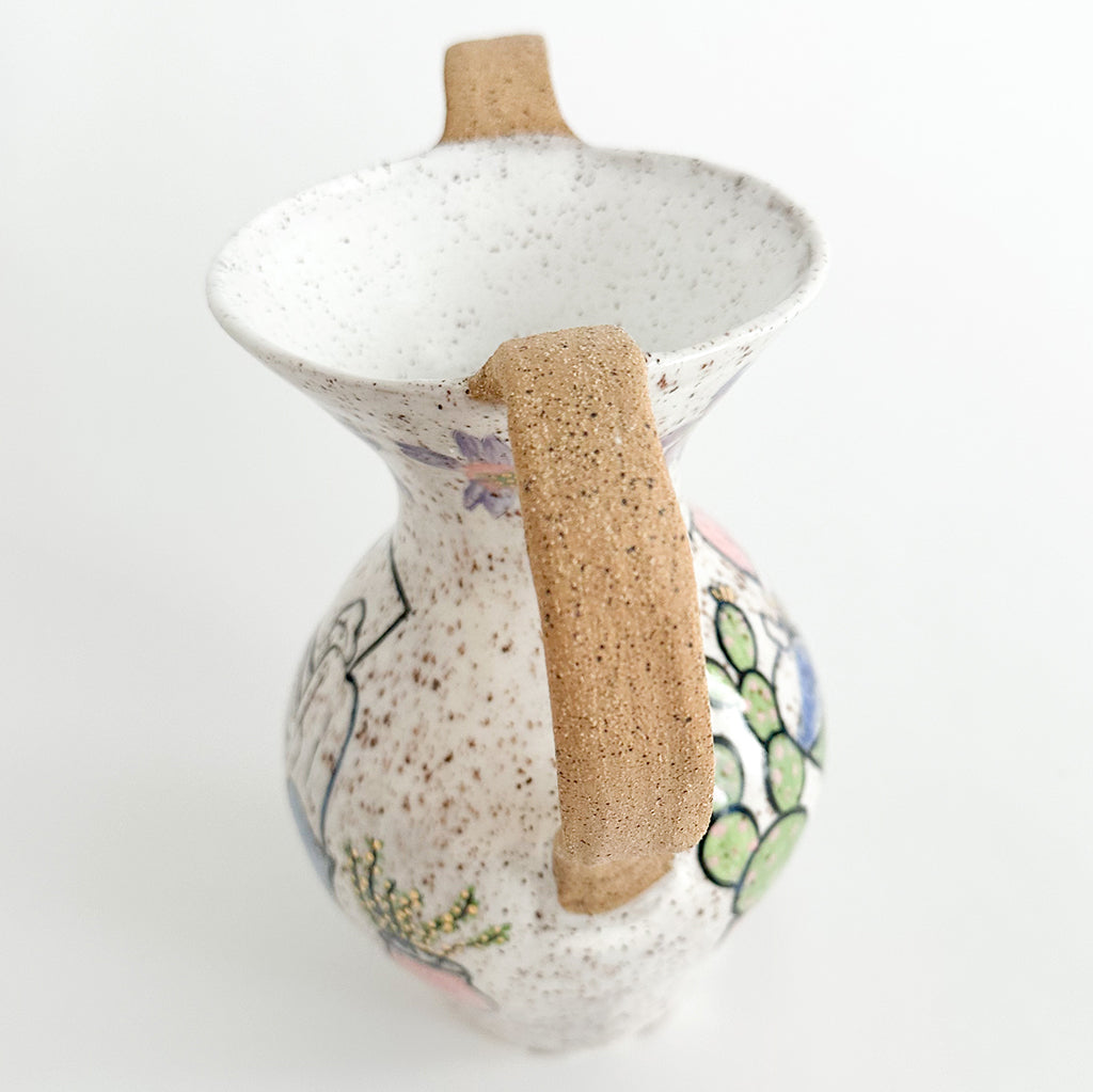 Photograph of a ceramic vase with multicolor glaze and drawings of a figure bathing by Jen Dwyer