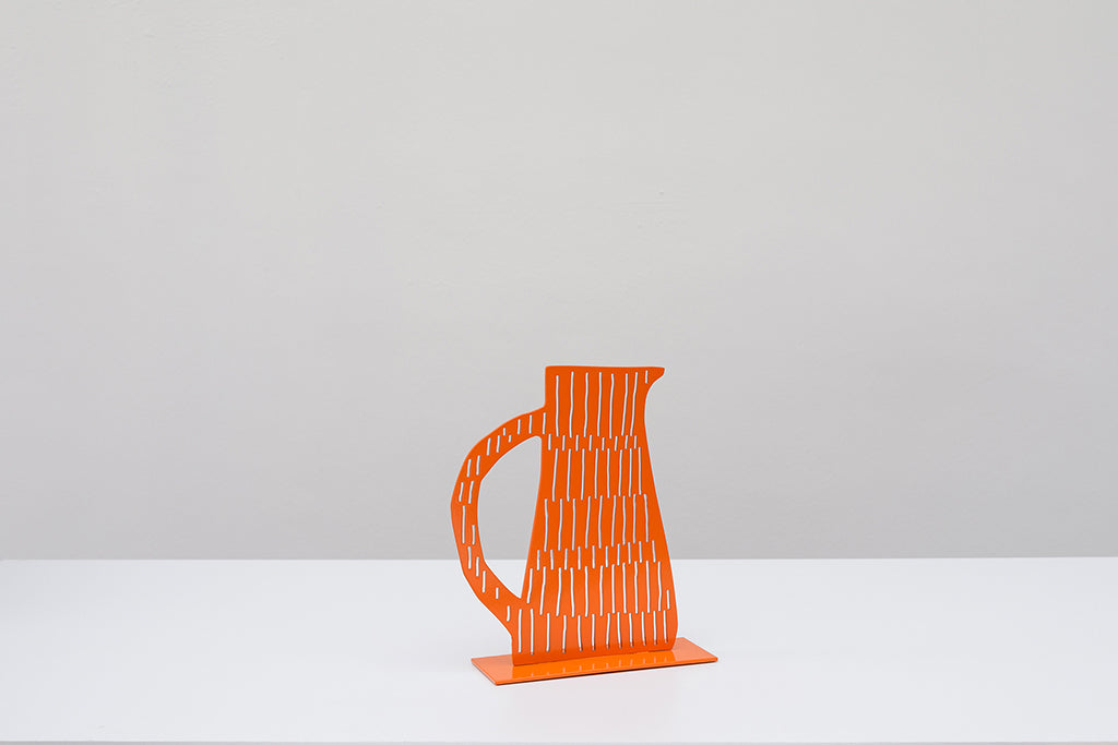 Steel sculpture of a red jug with cutout lines 