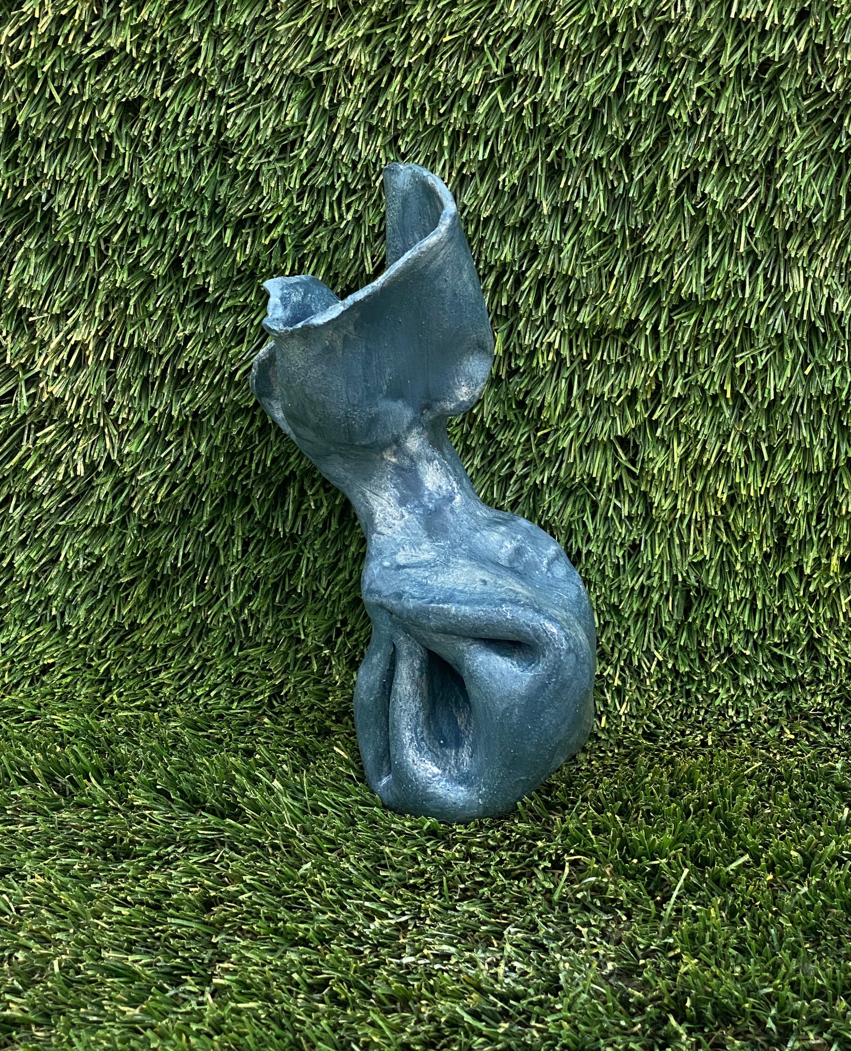 Ceramic sculpture of dog poop bag in blue